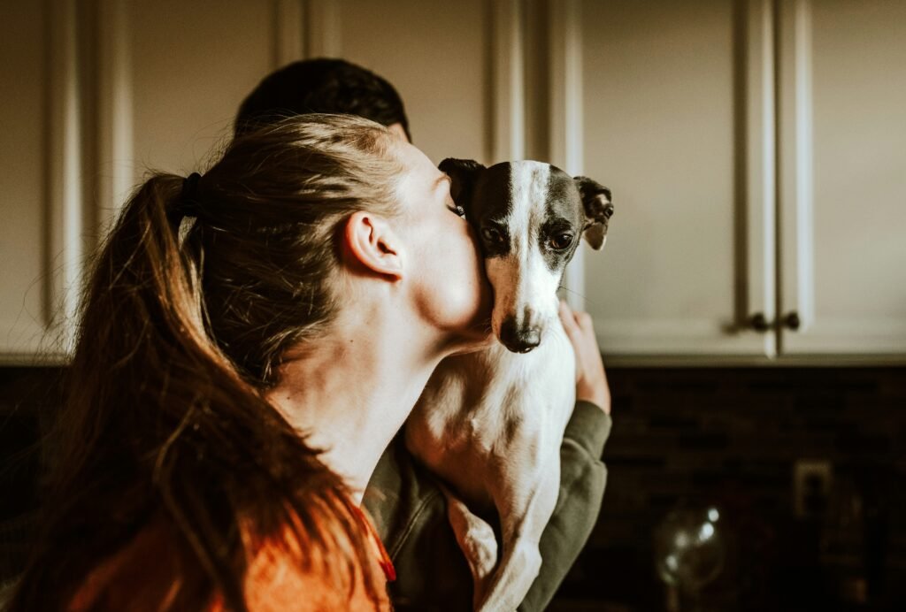 A girl kisses a dog