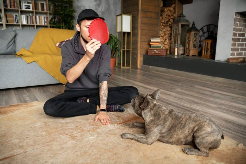 a man sitting on the floor with a frisbee in front of his face